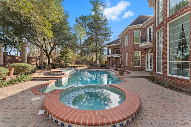 view of swimming pool with an in ground hot tub and a patio