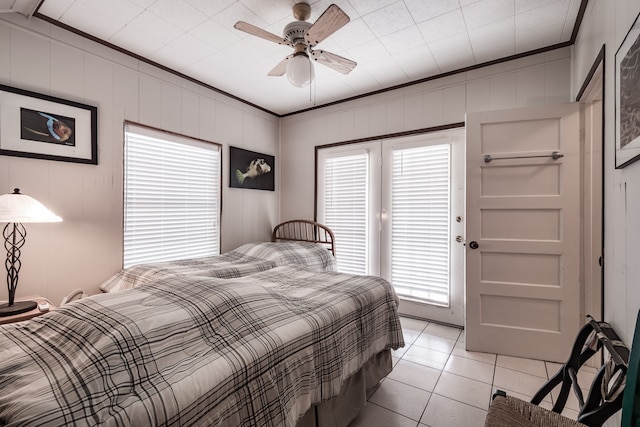 tiled bedroom with ceiling fan, ornamental molding, and multiple windows