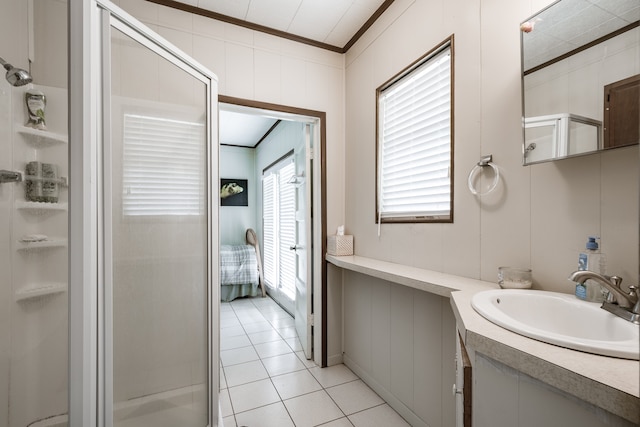 bathroom featuring vanity, a healthy amount of sunlight, ornamental molding, and a shower with door