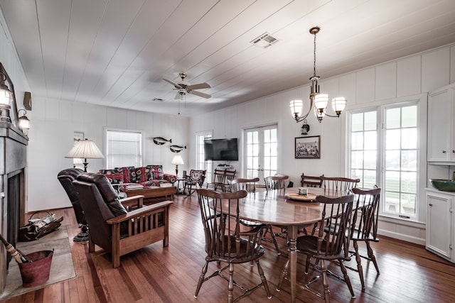 dining room featuring wood-type flooring and ceiling fan with notable chandelier