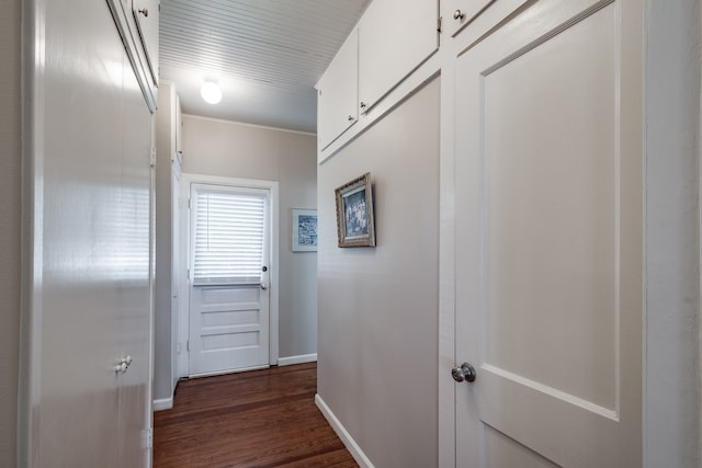 hallway featuring crown molding and dark wood-type flooring