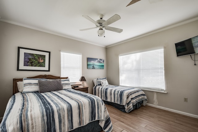 bedroom featuring light hardwood / wood-style floors, ceiling fan, and ornamental molding