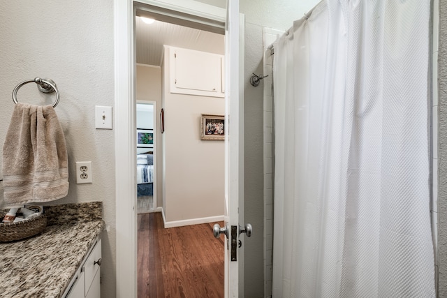 bathroom with vanity and wood-type flooring