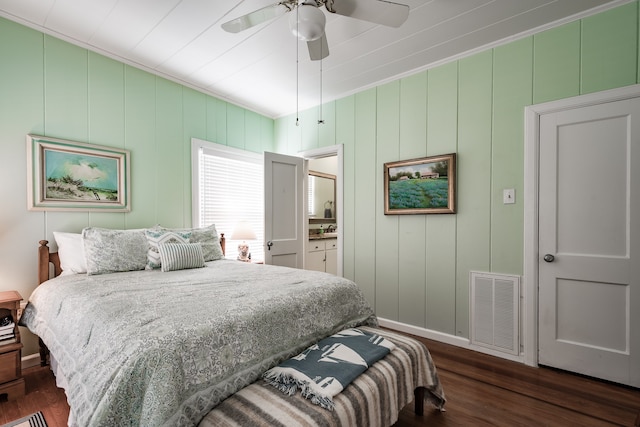 bedroom featuring ceiling fan, dark hardwood / wood-style flooring, and crown molding