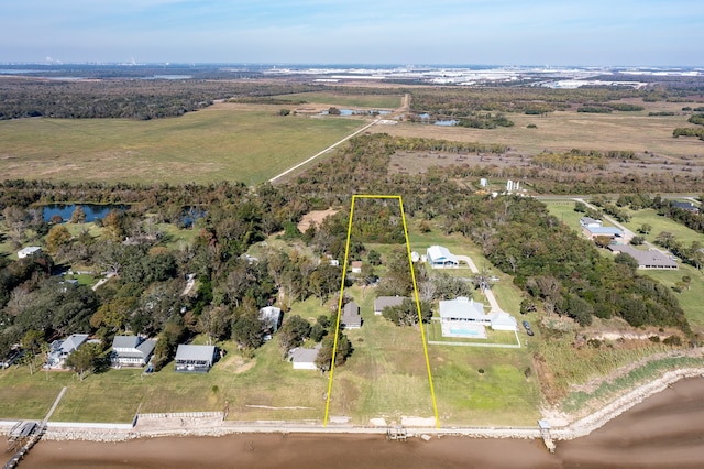 birds eye view of property with a rural view and a water view