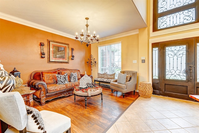 living room featuring a chandelier, light hardwood / wood-style flooring, and crown molding