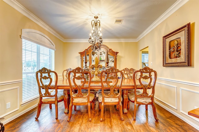 dining space with plenty of natural light, wood-type flooring, and ornamental molding