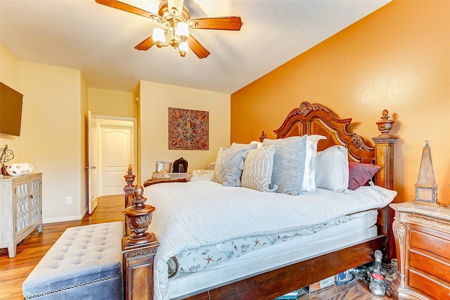 bedroom with ceiling fan and hardwood / wood-style flooring