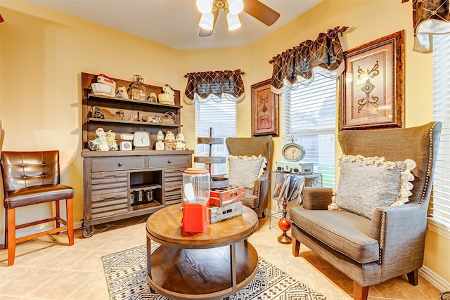 living area featuring ceiling fan and light tile patterned flooring