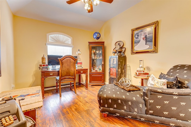 sitting room with lofted ceiling, ceiling fan, and wood-type flooring