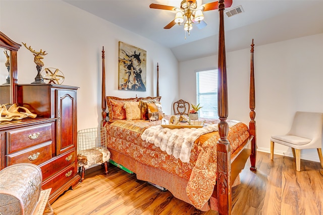 bedroom featuring light hardwood / wood-style flooring, ceiling fan, and lofted ceiling