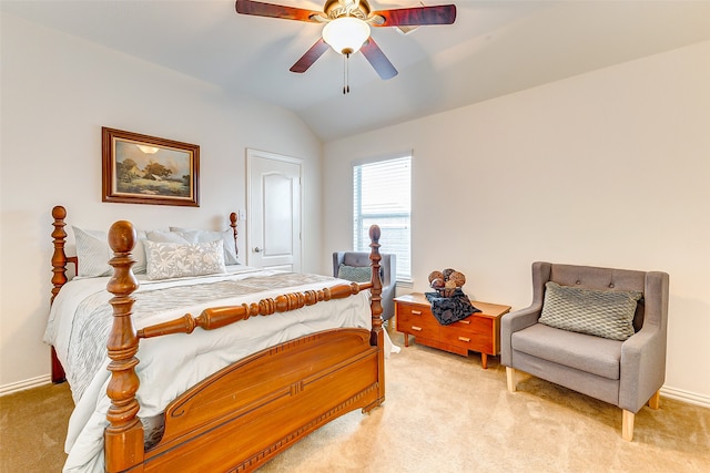 bedroom with light colored carpet, vaulted ceiling, and ceiling fan