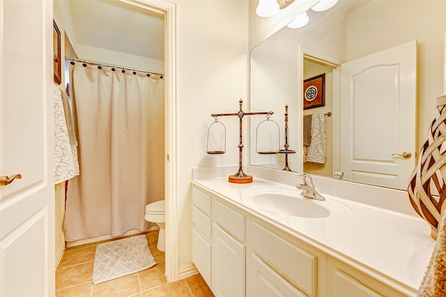 bathroom with tile patterned flooring, vanity, curtained shower, and toilet