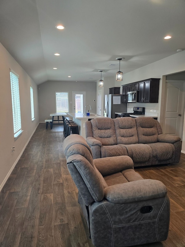 living room featuring dark hardwood / wood-style floors and lofted ceiling