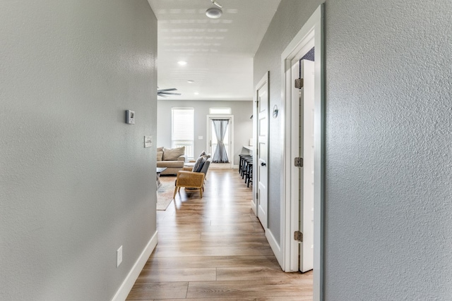 hallway with light hardwood / wood-style flooring