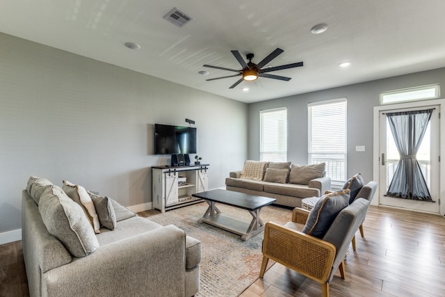 living room with ceiling fan and light wood-type flooring