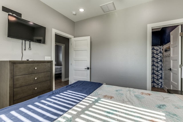 bedroom with dark wood-type flooring