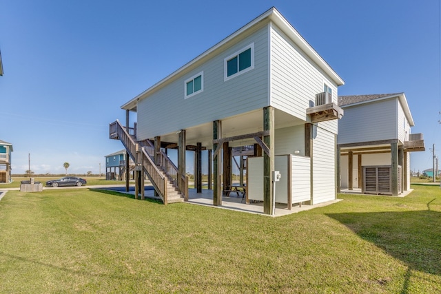 back of house featuring a yard and a patio