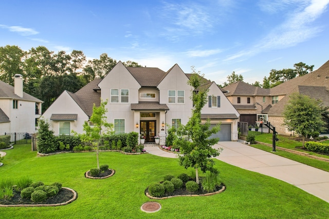 view of front of house with french doors, a front lawn, and a garage