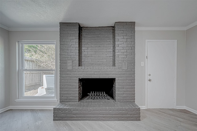 interior details with a fireplace, hardwood / wood-style floors, a textured ceiling, and ornamental molding