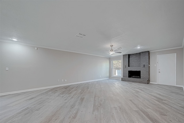 unfurnished living room with ceiling fan, light hardwood / wood-style floors, crown molding, and a fireplace