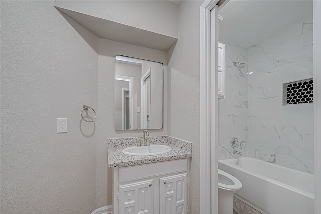 full bathroom with vanity, tiled shower / bath combo, and toilet