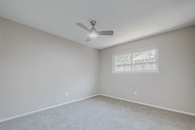 spare room featuring ceiling fan and carpet