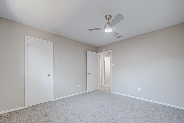 empty room with carpet flooring and ceiling fan