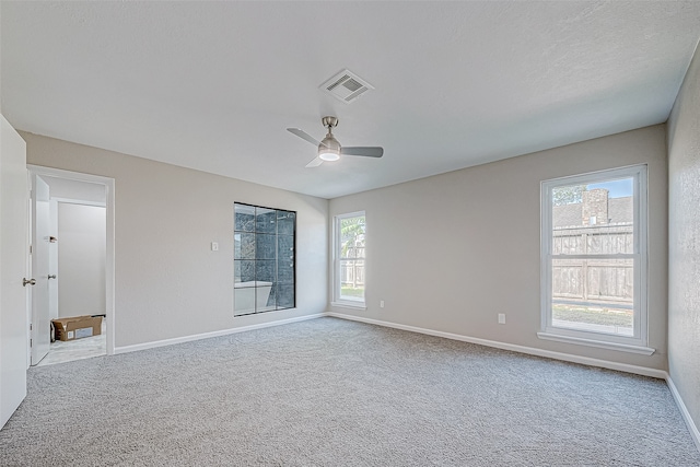 empty room with light colored carpet and ceiling fan