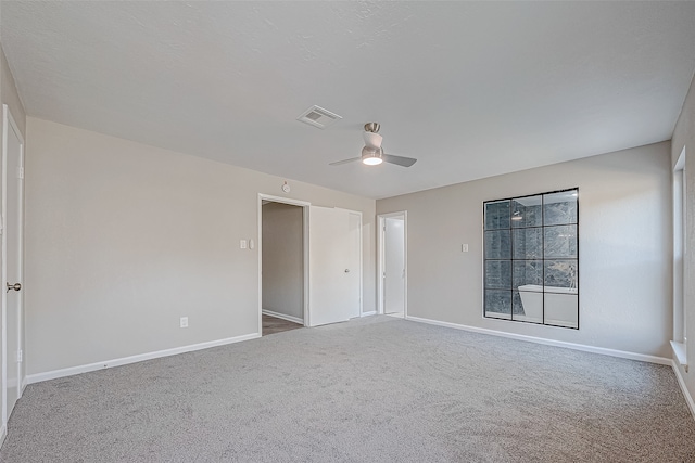 spare room with carpet and ceiling fan