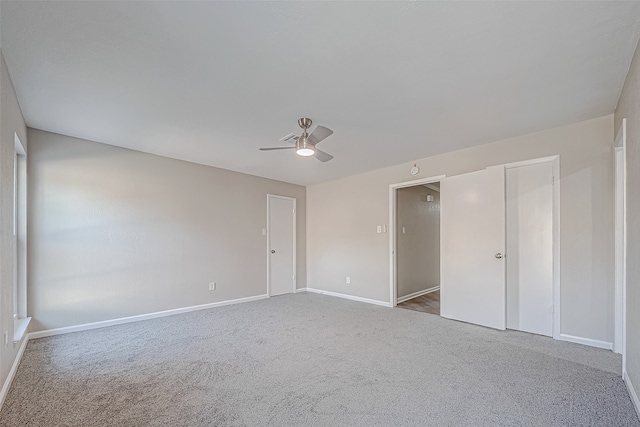 carpeted spare room with ceiling fan