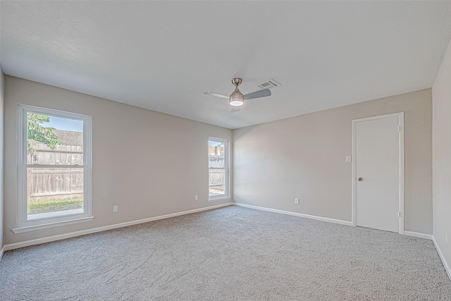 carpeted spare room with ceiling fan