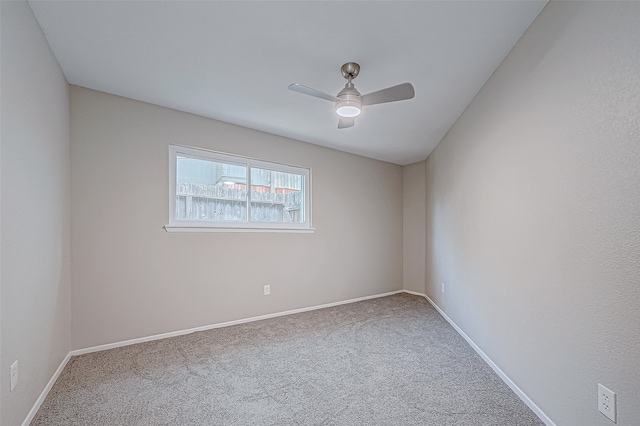 spare room featuring carpet and ceiling fan