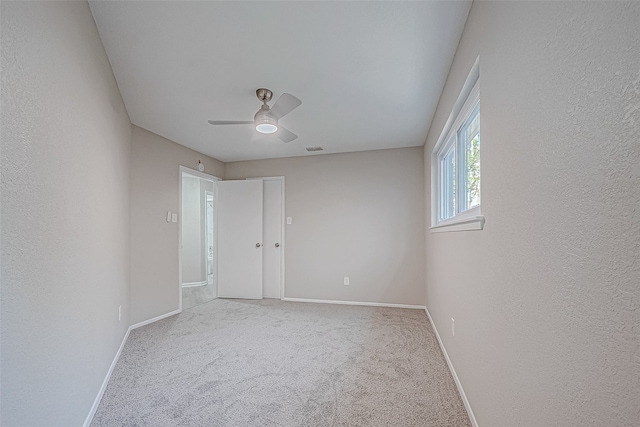 carpeted empty room with ceiling fan