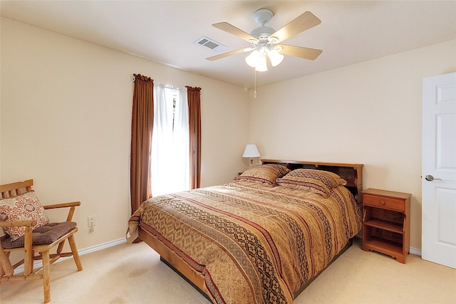 bedroom featuring ceiling fan and light carpet