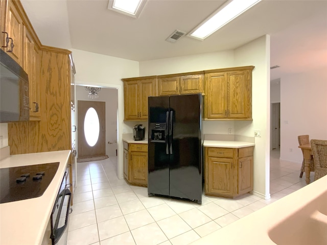 kitchen with light tile patterned floors and black appliances