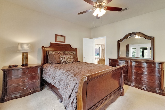 carpeted bedroom with ceiling fan and multiple windows