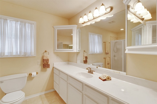 bathroom with toilet, vanity, tile patterned floors, and an enclosed shower