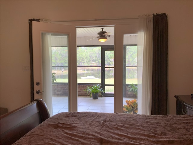 tiled bedroom featuring ceiling fan