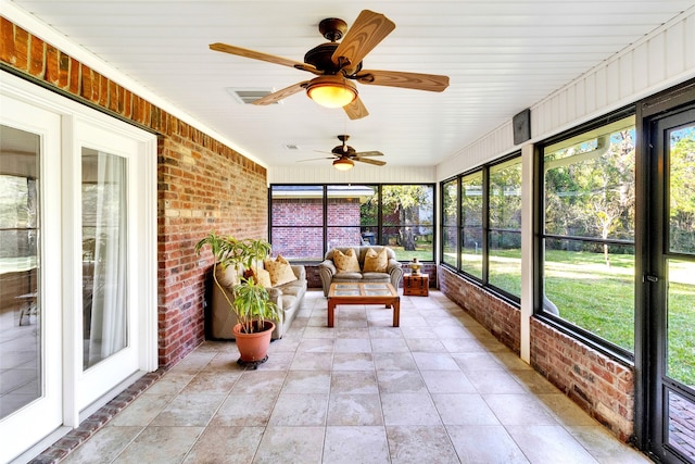 unfurnished sunroom featuring wood ceiling, a wealth of natural light, and ceiling fan