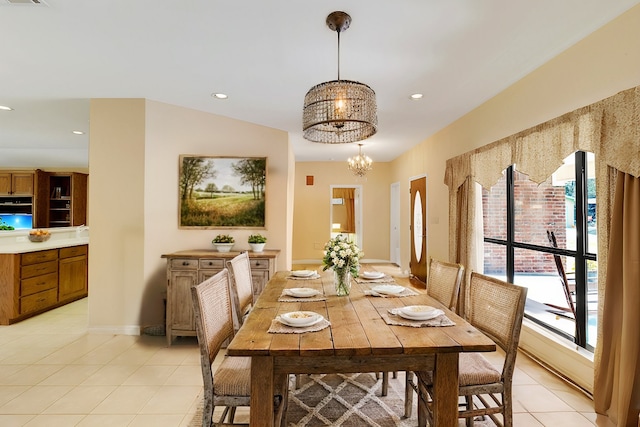 tiled dining space featuring a wealth of natural light, vaulted ceiling, and an inviting chandelier