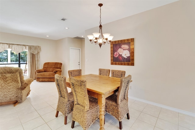 dining area with a chandelier and light tile patterned floors