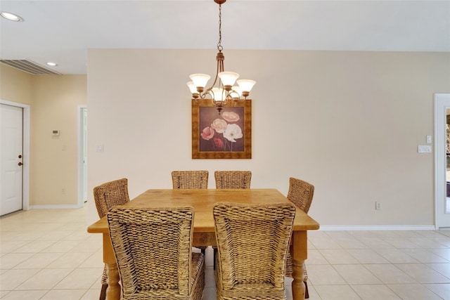 dining area with light tile patterned flooring and a notable chandelier