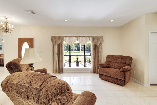 living area with light tile patterned floors and a notable chandelier