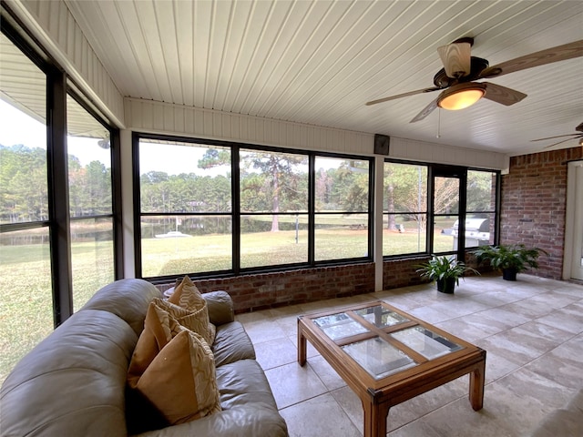 sunroom / solarium with ceiling fan, a healthy amount of sunlight, and wood ceiling