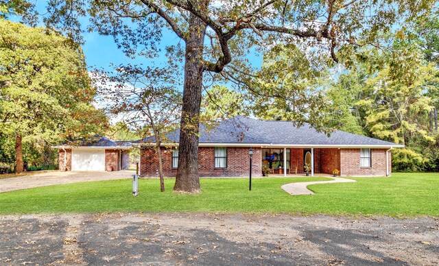 single story home with a garage and a front lawn