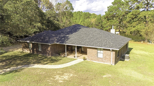 single story home featuring central air condition unit, a patio area, and a front yard