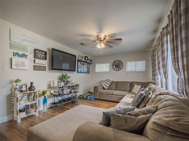 living room featuring hardwood / wood-style floors and ceiling fan