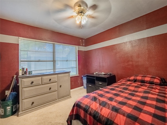 bedroom featuring ceiling fan and light carpet