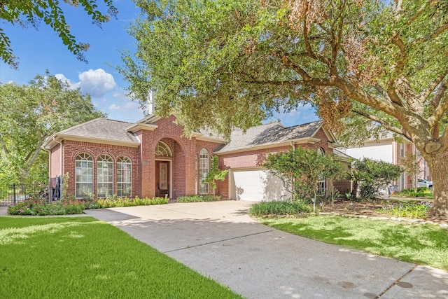 view of front of property featuring a garage and a front lawn